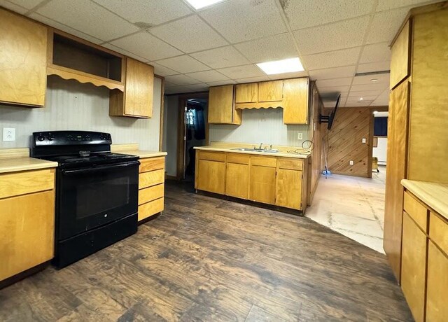 235 S Reynolds Rd, Winslow, ME 04901 - kitchen featuring black range with electric cooktop, light countertops, dark wood-style floors, a drop ceiling, and wood walls