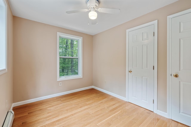 204 Youngs Ridge Rd, Acton, ME 04001 - unfurnished bedroom featuring a baseboard heating unit, light wood-type flooring, and a ceiling fan