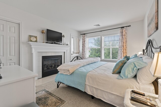 10 Barefoot Cottage Rd Unit 124, Wells, ME 04090 - bedroom featuring a tiled fireplace