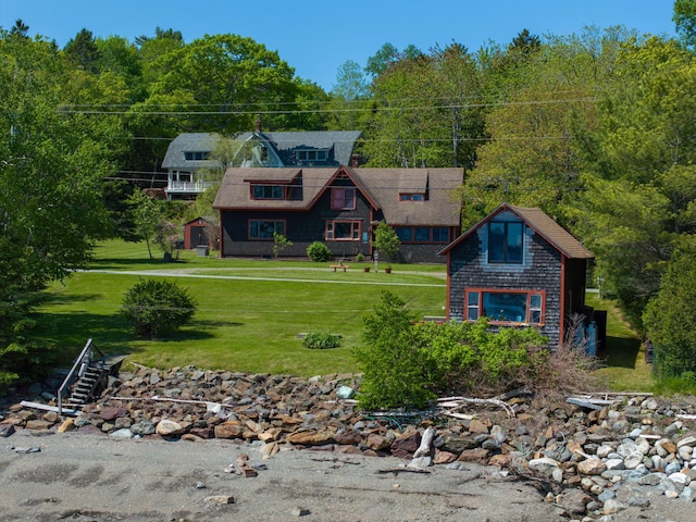364 Main Rd, Islesboro, ME 04848 - shingle-style home with a front yard, an outbuilding, and a wooded view