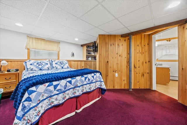 182 Myrtle St, Westbrook, ME 04092 - bedroom featuring wood walls, a baseboard radiator, carpet floors, a wainscoted wall, and a drop ceiling