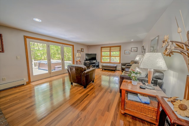 82 Eaton Ridge Dr, Holden, ME 04429 - living room with light wood-style flooring, recessed lighting, and a baseboard radiator