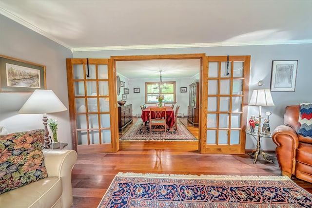 82 Eaton Ridge Dr, Holden, ME 04429 - living area featuring hardwood / wood-style flooring, crown molding, and a baseboard radiator