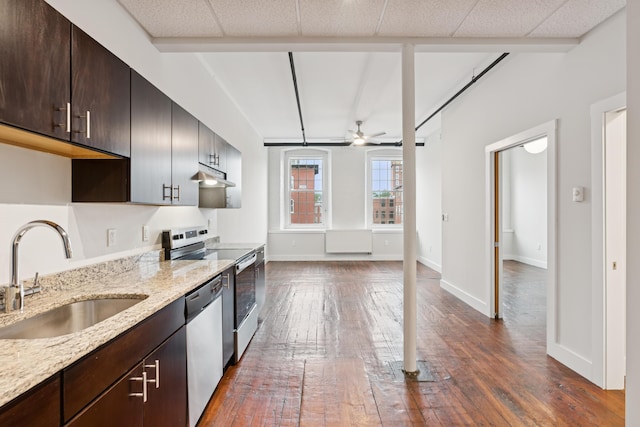 2 Main St Unit 17-415, Biddeford, ME 04005 - kitchen featuring appliances with stainless steel finishes, under cabinet range hood, dark wood-type flooring, and a ceiling fan