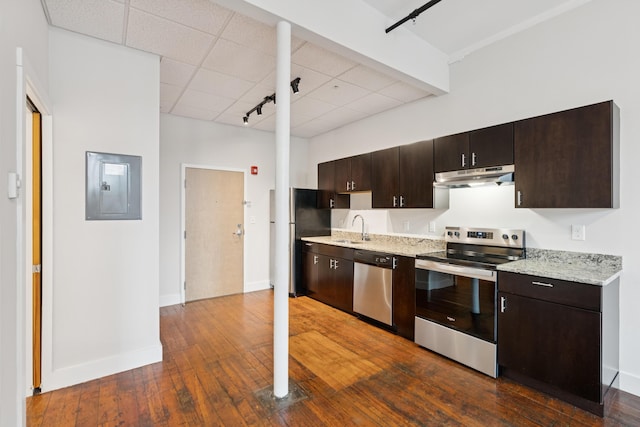 2 Main St Unit 17-415, Biddeford, ME 04005 - kitchen featuring appliances with stainless steel finishes, under cabinet range hood, electric panel, dark wood-style floors, and a paneled ceiling