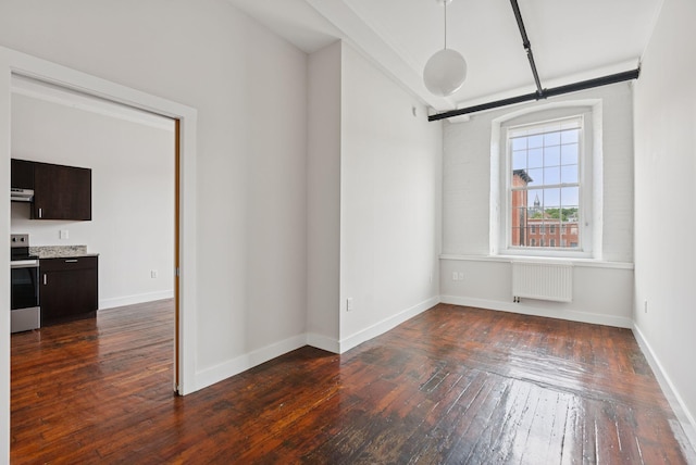 2 Main St Unit 17-415, Biddeford, ME 04005 - spare room with radiator and dark wood-style floors