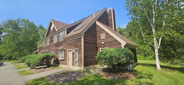 9 Hubbard Farms Rd Unit 15, Orono, ME 04473 - view of side of home featuring a chimney, a lawn, and a shingled roof