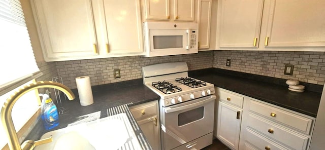 9 Hubbard Farms Rd Unit 15, Orono, ME 04473 - kitchen with white appliances, dark countertops, tasteful backsplash, and white cabinets