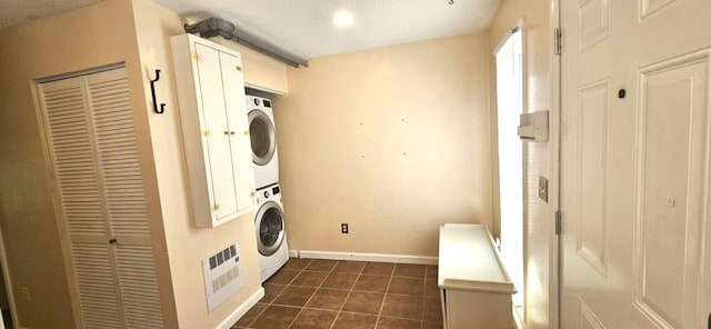 9 Hubbard Farms Rd Unit 15, Orono, ME 04473 - laundry room with stacked washer / dryer and dark tile patterned floors
