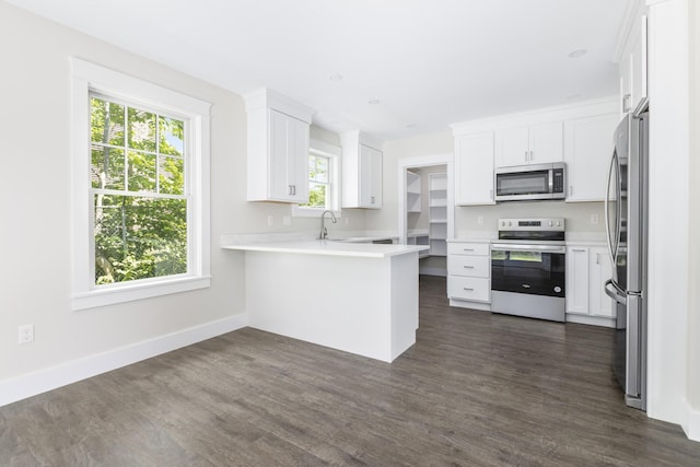 24 Varney Mill Rd Unit 3, Windham, ME 04062 - kitchen featuring appliances with stainless steel finishes, a peninsula, dark wood-type flooring, and white cabinets