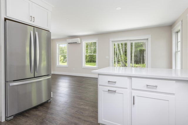 24 Varney Mill Rd Unit 3, Windham, ME 04062 - kitchen with freestanding refrigerator, a wall mounted AC, dark wood-type flooring, light countertops, and white cabinets