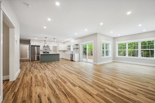 18 Crestwood Dr, Orrington, ME 04474 - unfurnished living room featuring light wood finished floors and recessed lighting