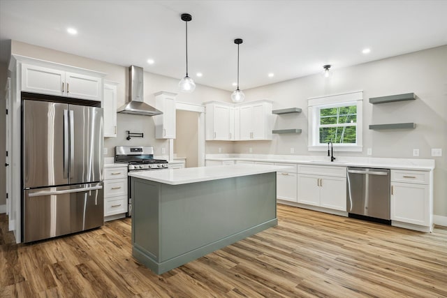 18 Crestwood Dr, Orrington, ME 04474 - kitchen featuring appliances with stainless steel finishes, open shelves, wall chimney range hood, light countertops, and light wood finished floors