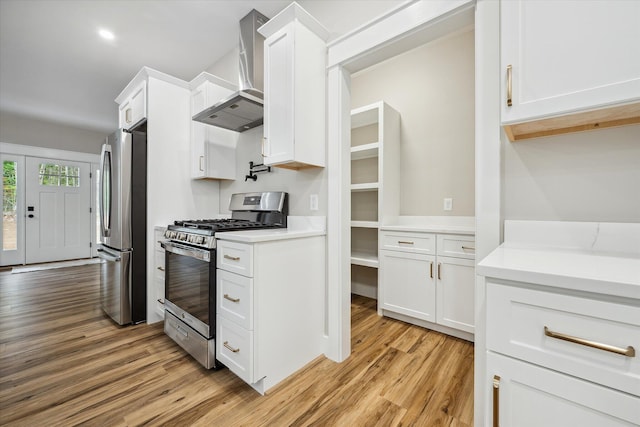 18 Crestwood Dr, Orrington, ME 04474 - kitchen with appliances with stainless steel finishes, wall chimney exhaust hood, light wood-style floors, white cabinetry, and light countertops