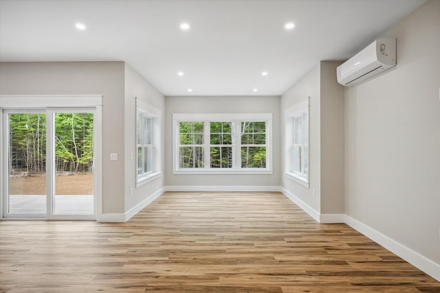 18 Crestwood Dr, Orrington, ME 04474 - spare room with a wall unit AC, light wood-style floors, and recessed lighting