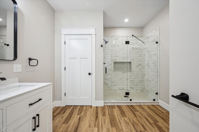 18 Crestwood Dr, Orrington, ME 04474 - bathroom featuring a stall shower, vanity, wood finished floors, and recessed lighting