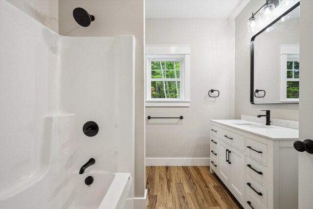 18 Crestwood Dr, Orrington, ME 04474 - full bath featuring vanity, wood finished floors, and shower / tub combination