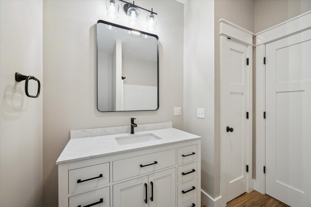 18 Crestwood Dr, Orrington, ME 04474 - bathroom with vanity and wood finished floors