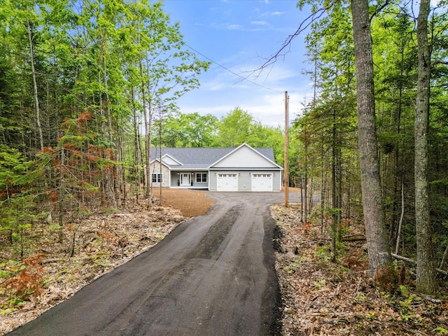 18 Crestwood Dr, Orrington, ME 04474 - view of front facade featuring an attached garage and dirt driveway
