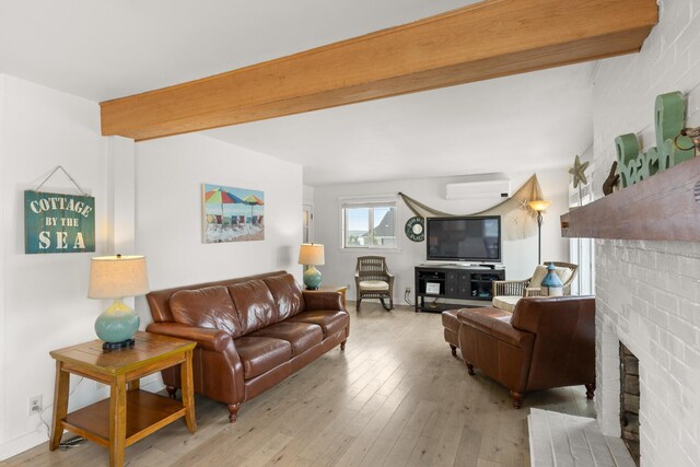 265 Nubble Rd, York, ME 03909 - living area with a fireplace, hardwood / wood-style flooring, beam ceiling, and an AC wall unit