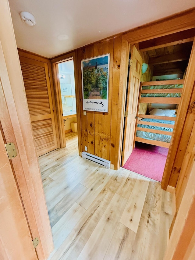705 Webber St Unit 3, Carrabassett Valley, ME 04947 - unfurnished bedroom featuring a baseboard heating unit, wood finished floors, and ensuite bath