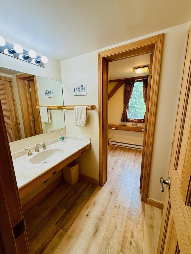 705 Webber St Unit 3, Carrabassett Valley, ME 04947 - bathroom featuring wood-type flooring, vanity, and baseboard heating