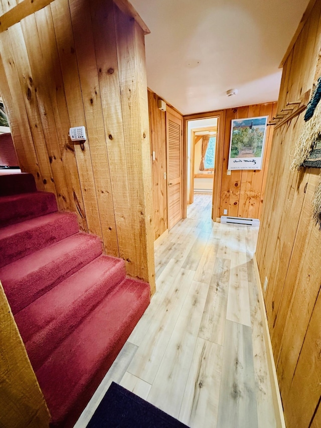705 Webber St Unit 3, Carrabassett Valley, ME 04947 - staircase with wood walls, baseboard heating, and hardwood / wood-style floors
