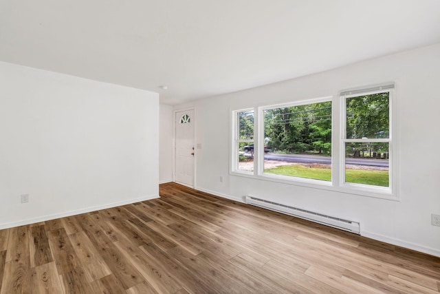 290 Gray Rd, Windham, ME 04062 - empty room with baseboard heating and wood finished floors