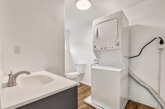 290 Gray Rd, Windham, ME 04062 - bathroom with stacked washing machine and dryer, vanity, and wood finished floors