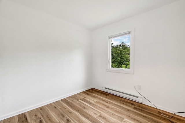 290 Gray Rd, Windham, ME 04062 - empty room with a baseboard heating unit and light wood-style flooring