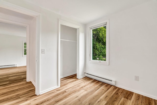 290 Gray Rd, Windham, ME 04062 - unfurnished bedroom featuring a baseboard heating unit, wood finished floors, and a closet