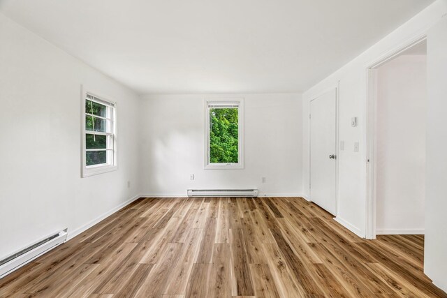 290 Gray Rd, Windham, ME 04062 - unfurnished room with a baseboard heating unit and light wood-style flooring