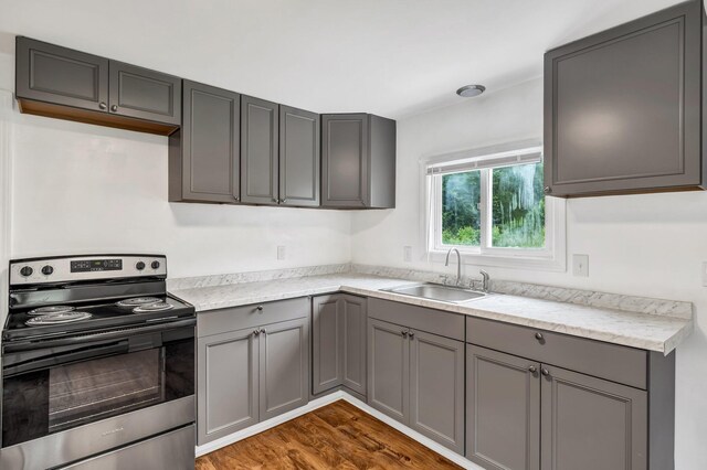 290 Gray Rd, Windham, ME 04062 - kitchen with stainless steel electric range oven, gray cabinets, light countertops, and dark wood-style floors