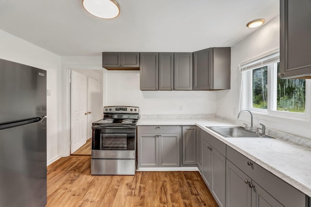 290 Gray Rd, Windham, ME 04062 - kitchen with stainless steel appliances, gray cabinets, light wood finished floors, and light countertops