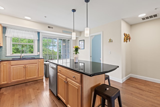 180 E Grand Ave Unit 3, Old Orchard Beach, ME 04064 - kitchen with light wood-type flooring, dark countertops, a kitchen bar, dishwasher, and recessed lighting