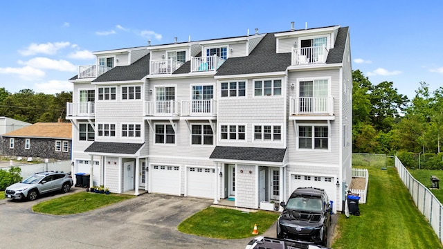 180 E Grand Ave Unit 3, Old Orchard Beach, ME 04064 - view of front facade featuring an attached garage, driveway, a shingled roof, and a balcony