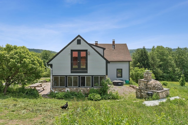 30 Graffam Rd, Baldwin, ME 04091 - back of property with a chimney, stone siding, and roof with shingles