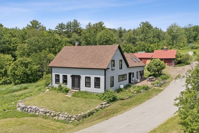 30 Graffam Rd, Baldwin, ME 04091 - view of front of property with a chimney, roof with shingles, a front yard, and a view of trees