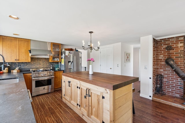 30 Graffam Rd, Baldwin, ME 04091 - kitchen featuring appliances with stainless steel finishes, wall chimney range hood, decorative backsplash, a chandelier, and butcher block countertops