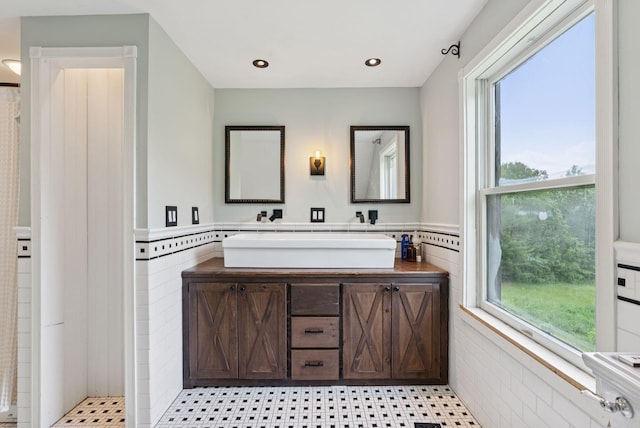 30 Graffam Rd, Baldwin, ME 04091 - full bath with healthy amount of natural light, double vanity, wainscoting, curtained shower, and recessed lighting