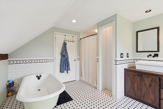 30 Graffam Rd, Baldwin, ME 04091 - full bath featuring tile walls, a freestanding bath, vanity, a wainscoted wall, and vaulted ceiling