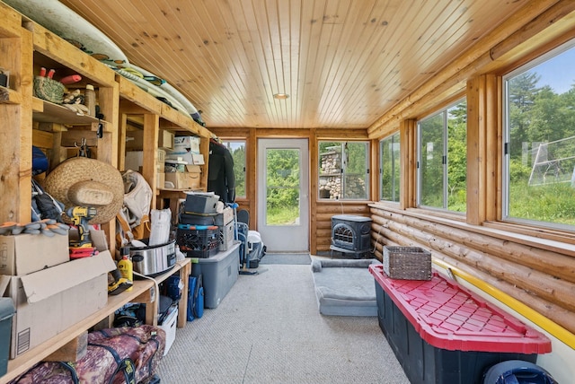 30 Graffam Rd, Baldwin, ME 04091 - sunroom with log walls, wood ceiling, carpet floors, healthy amount of natural light, and a wood stove