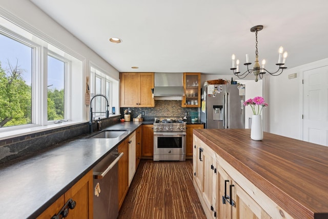 30 Graffam Rd, Baldwin, ME 04091 - kitchen featuring wall chimney range hood, stainless steel appliances, wood counters, a chandelier, and decorative backsplash