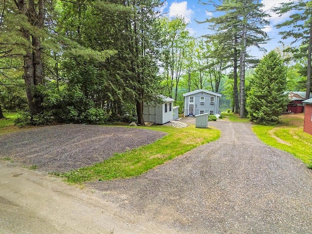 75 Spaulding Point Rd, Belgrade, ME 04917 - view of front facade with asphalt driveway and an outdoor structure