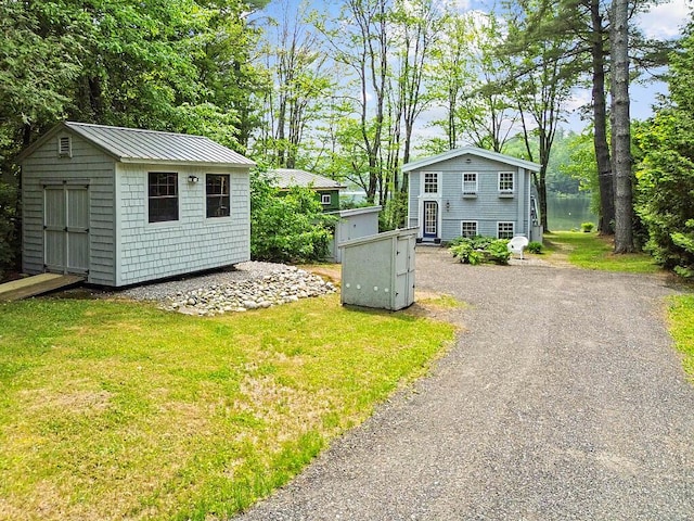 75 Spaulding Point Rd, Belgrade, ME 04917 - exterior space with a shed and view of scattered trees