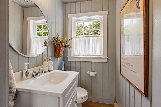 75 Spaulding Point Rd, Belgrade, ME 04917 - bathroom with wooden walls, vanity, and wood finished floors