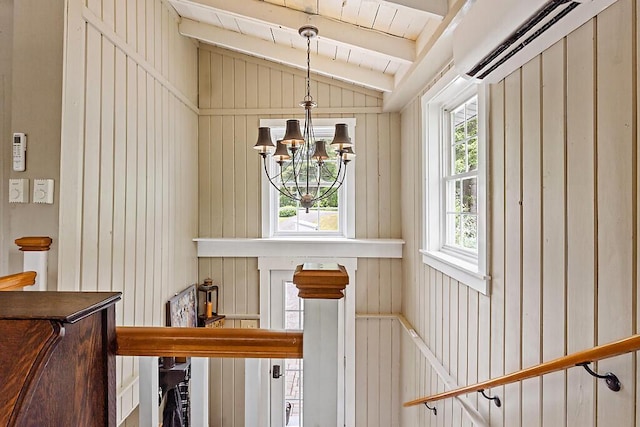 75 Spaulding Point Rd, Belgrade, ME 04917 - stairway featuring an AC wall unit and a chandelier