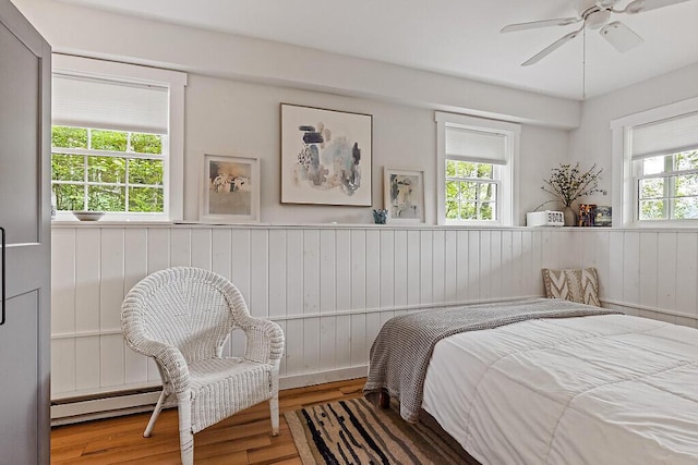 75 Spaulding Point Rd, Belgrade, ME 04917 - bedroom featuring wainscoting, wood finished floors, and ceiling fan