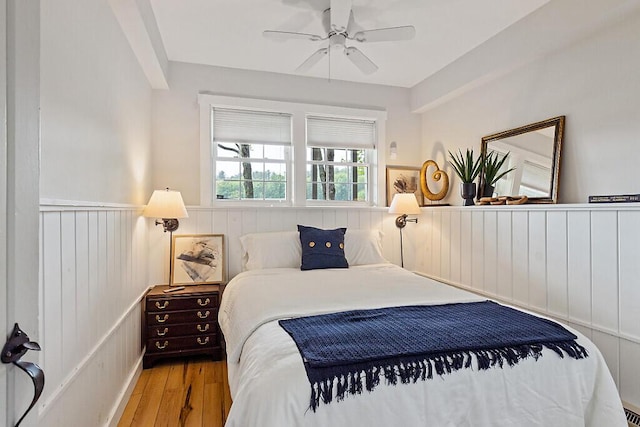 75 Spaulding Point Rd, Belgrade, ME 04917 - bedroom with wainscoting, wood finished floors, and ceiling fan