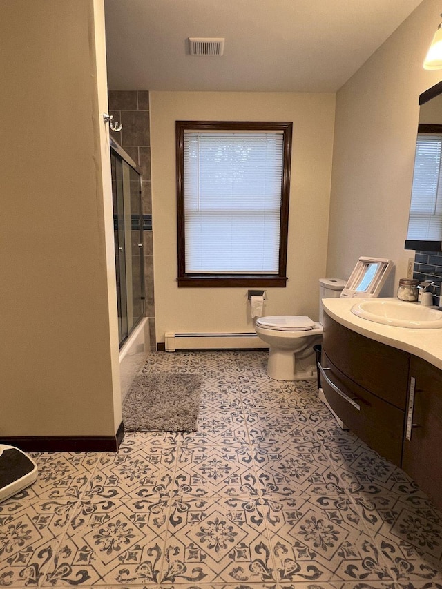 227 Back Rd, Skowhegan, ME 04976 - bathroom featuring baseboard heating, vanity, plenty of natural light, and enclosed tub / shower combo